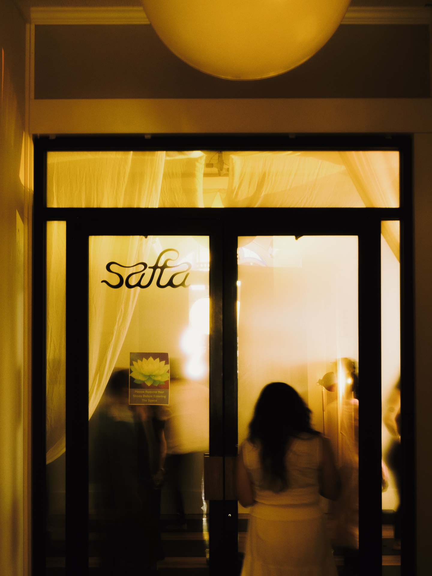 Guests entering Safta through the glowing studio door