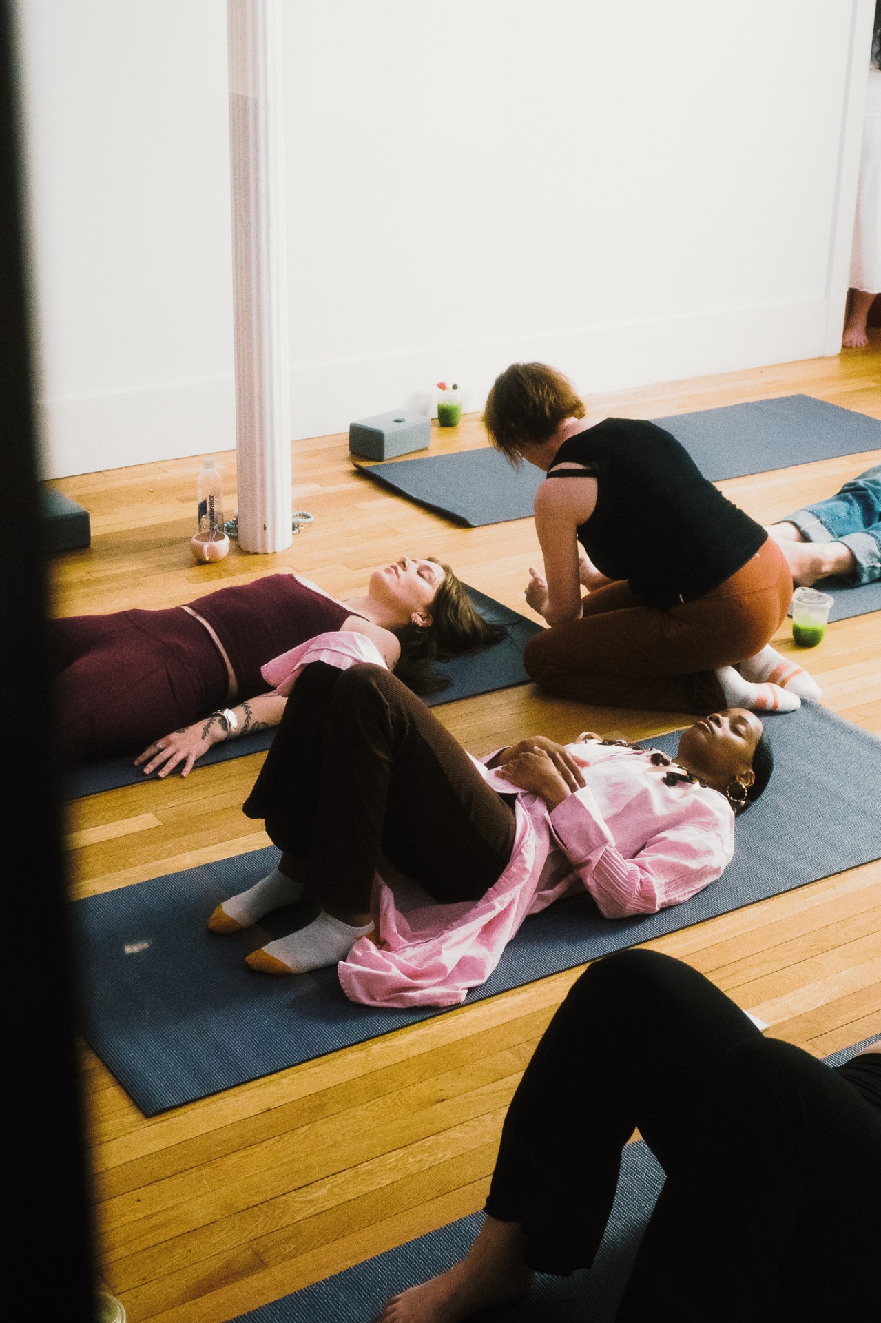 Hands-on assist during savasana
